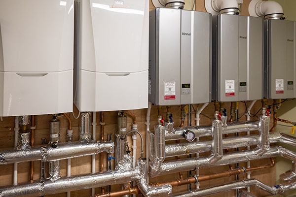 our care home construction services includes plumbing design and installaion - this image shows boiler installation and pipe work carried out by the ashby facilities team
